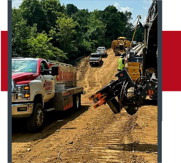 OilWorks Transport truck providing on-site fuel delivery to construction equipment on a dirt worksite.